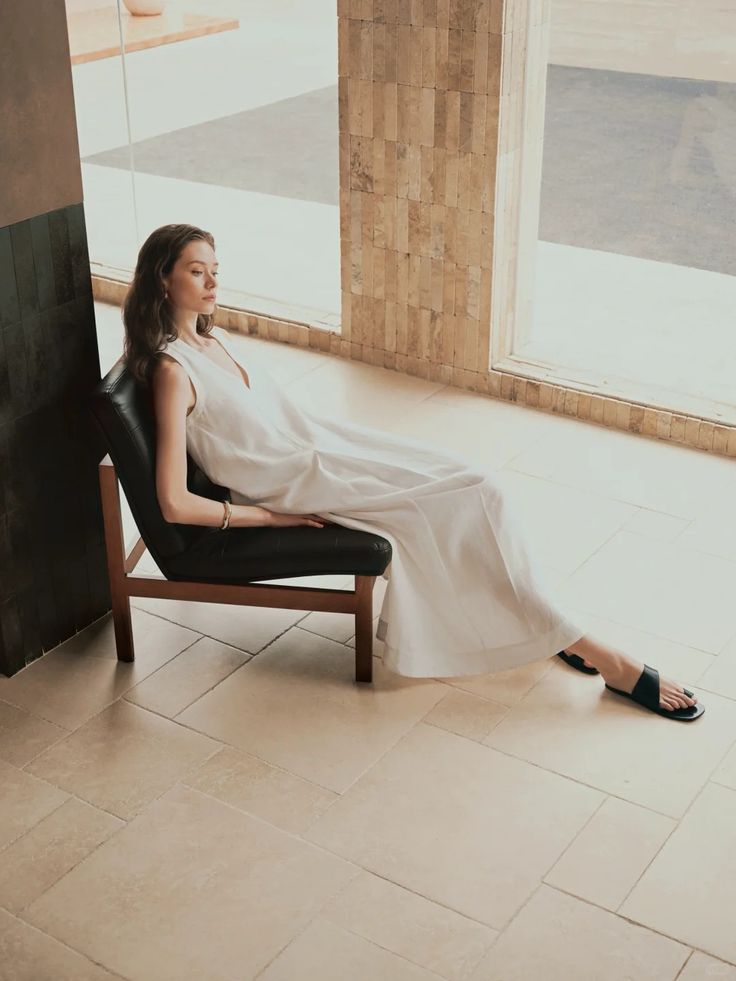 Woman wearing a flowing neutral dress indoors